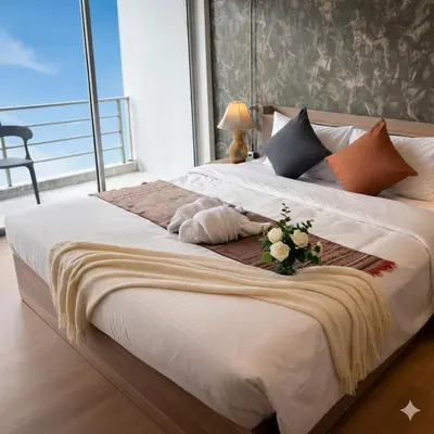 a bedroom with a large bed with flowers on it at Global Hills Hotel in Patong Beach
