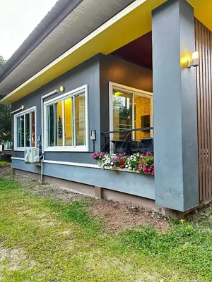 a house with a window box with flowers on it at Kamala cozy home in Kamala Beach