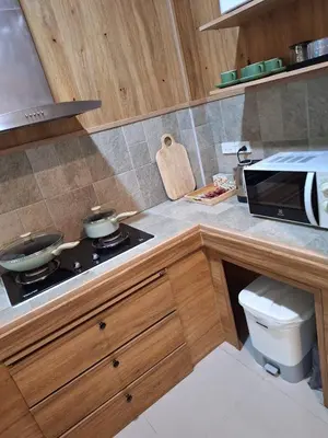 a kitchen with a stove and a microwave at Kamala cozy home in Kamala Beach