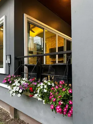 a window box with flowers on a balcony at Kamala cozy home in Kamala Beach