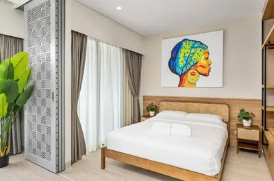 a bedroom with a bed and a painting on the wall at Laguna LakeSide Residences by My Home Phuket in Bang Tao Beach
