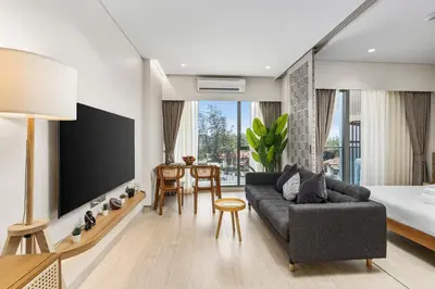 a living room with a couch and a tv at Laguna LakeSide Residences by My Home Phuket in Bang Tao Beach
