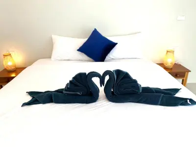 a bed with blue towels on top of it at GOODNIGHT Hill KOHYAOYAI in Ban Nai Wat