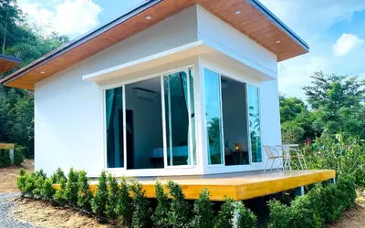 a small house with a large glass door at GOODNIGHT Hill KOHYAOYAI in Ban Nai Wat