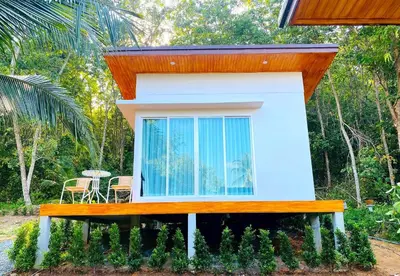 a small house with a bench in front of it at GOODNIGHT Hill KOHYAOYAI in Ban Nai Wat
