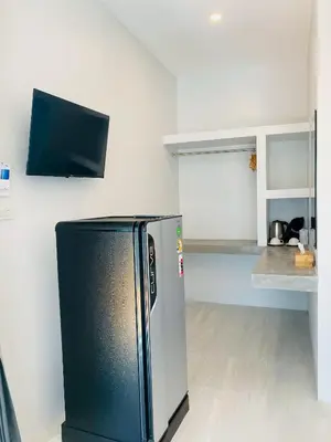 a kitchen with a black refrigerator in a room at GOODNIGHT Hill KOHYAOYAI in Ban Nai Wat
