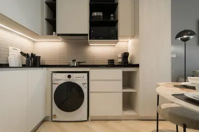 a kitchen with a washing machine in a kitchen at Title Legendary Apartment 800m to Bang Tao Beach in Bang Tao Beach