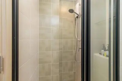 a bathroom with a shower with a glass door at C262 Relax 2BR Condo with Pool and Full Gym in Kathu