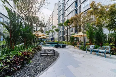 a courtyard with benches and trees and buildings at C262 Relax 2BR Condo with Pool and Full Gym in Kathu