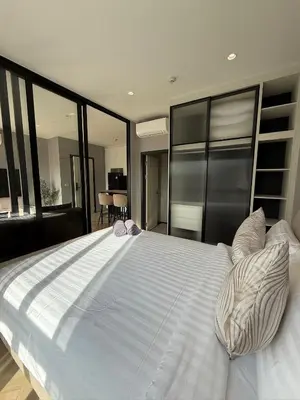 a large white bed in a room with large windows at Legendary F705 - Top floor family 1BR - The Title Legendary by UNO in Bang Tao Beach