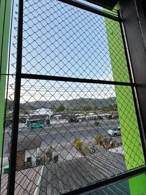 a view of a parking lot from a window at Atrium Kathu Hotel in Ban Kathu