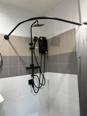 a shower in a bathroom with a shower at Atrium Kathu Hotel in Ban Kathu
