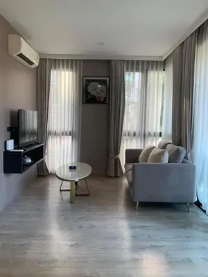 a living room with a couch and a table at Royal Lee The Terminal Phuket in Thalang