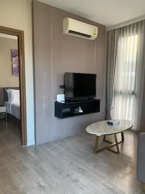 a living room with a tv and a coffee table at Royal Lee The Terminal Phuket in Thalang