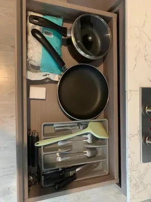 a drawer filled with cooking utensils and a pan at Royal Lee The Terminal Phuket in Thalang