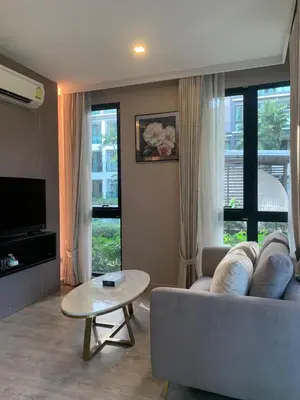 a living room with a couch and a table at Royal Lee The Terminal Phuket in Thalang