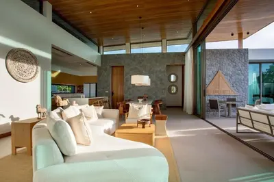a living room with a couch and a dining room at OASIS Luxury Private Villa in Ban Phru Champa
