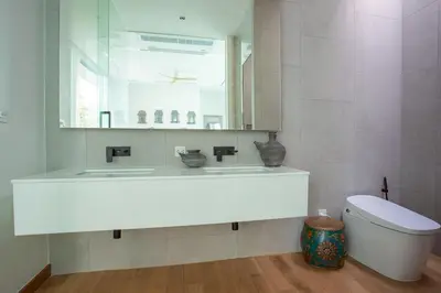 a bathroom with a sink and a toilet and a mirror at OASIS Luxury Private Villa in Ban Phru Champa