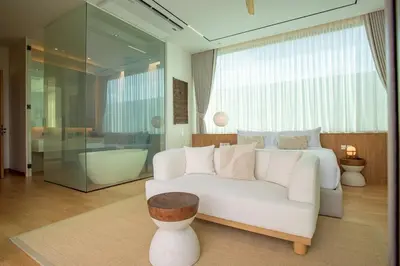 a living room with a white couch and a bed at OASIS Luxury Private Villa in Ban Phru Champa