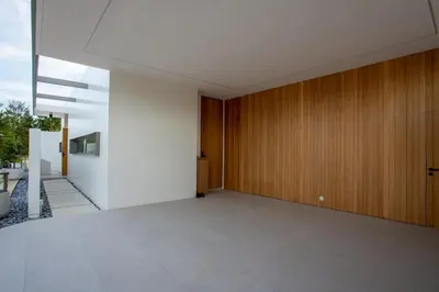 a hallway of a house with a wooden door at OASIS Luxury Private Villa in Ban Phru Champa