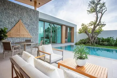 a patio with a pool and a table and chairs at OASIS Luxury Private Villa in Ban Phru Champa