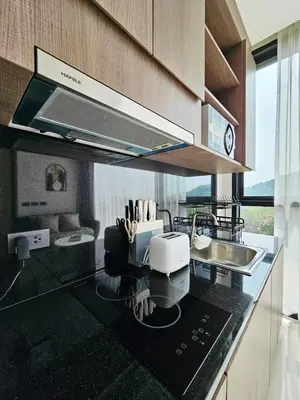 a kitchen with a counter top with a sink and aounter at patong see view condo in Patong Beach