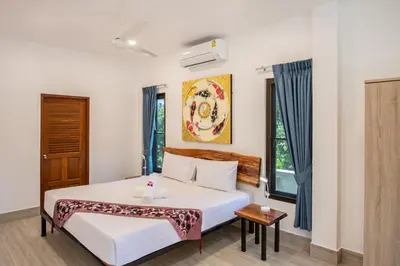 a bedroom with a bed and a window at Large Private Pool 5BR Villa Tony near Promthep Cape in Nai Harn Beach