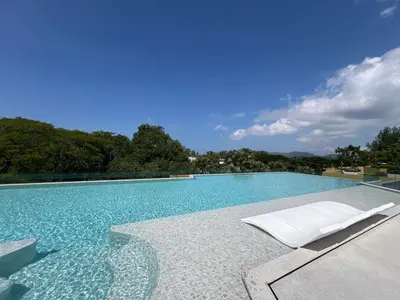 a swimming pool with a couch and a chair at 3 bedrooms in Laguna, Bangtao Beach 5 min walk in Bang Tao Beach