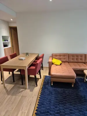 a dining room with a couch and a table and chairs at 3 bedrooms in Laguna, Bangtao Beach 5 min walk in Bang Tao Beach
