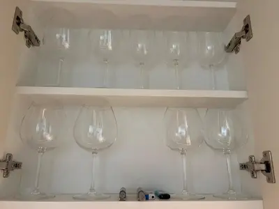a bunch of wine glasses are on a shelf at 3 bedrooms in Laguna, Bangtao Beach 5 min walk in Bang Tao Beach