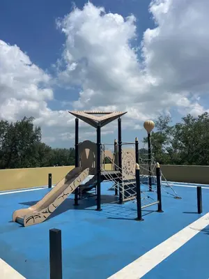 a playground with a slide on a blue court at 3 bedrooms in Laguna, Bangtao Beach 5 min walk in Bang Tao Beach