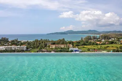 a view from the water of a beach at Ocean Breeze 1-BR apartment, Sea View, Surin beach in Ban Lum Fuang