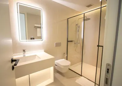 a bathroom with a shower and a toilet and a sink at Kora 267 3BR Condo with Pool View in Phuket Town