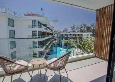a balcony with a view of a pool and a hotel at Kora 267 3BR Condo with Pool View in Phuket Town