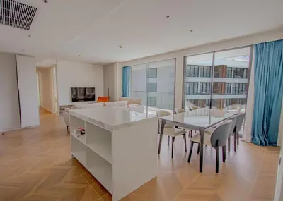 a kitchen and dining room with a table and chairs at Kora 267 3BR Condo with Pool View in Phuket Town