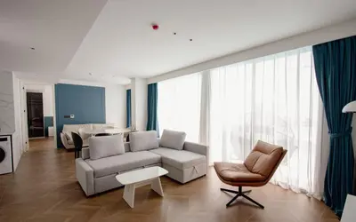 a living room with a couch and a chair at Kora 222 3BR Condo with Pool Access in Phuket Town