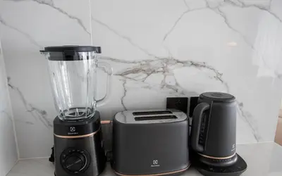 a blender sitting on a counter next to two other appliances at Kora 222 3BR Condo with Pool Access in Phuket Town