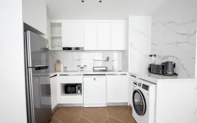 a white kitchen with a washer and dryer at Kora 222 3BR Condo with Pool Access in Phuket Town