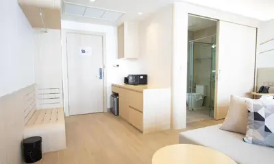 a small apartment with a kitchen and a living room at One Bedroom Wyndham Naithon with Jacuzzi in Phuket Town
