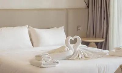 two swans made out of towels on a bed at One Bedroom Wyndham Naithon with Jacuzzi in Phuket Town