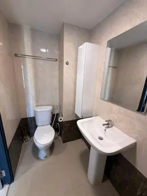 a bathroom with a toilet and a sink and a mirror at FAMILY HOMES Mai Khao Poolside Studio CB-845 Near Sirinat Park in Ban Mai Salae