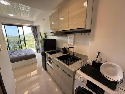 a small kitchen with a sink and a stove at FAMILY HOMES Mai Khao Poolside Studio CB-845 Near Sirinat Park in Ban Mai Salae