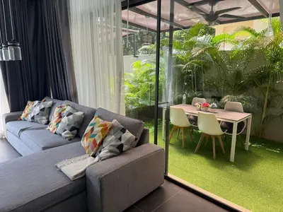 a living room with a couch and a table at Villa DIAZ RAWAI in Ban Saiyuan (1)