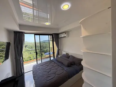 a small bedroom with a bed and a window at The Signature Studio at Mai Khao by FAMILY HOMES CB-846 in Ban Mai Salae
