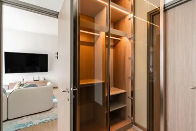 a bathroom with a walk in closet with a television at Canvas Apartments in Laguna Phuket