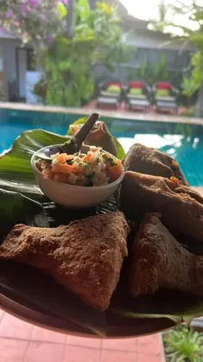 a plate of food with a bowl of food at Watermelon House at Nong Thale Garden & Kitchen in Ban Khao Klom