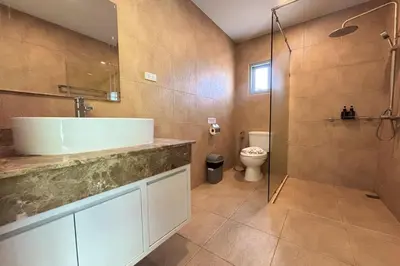 a bathroom with a sink and a shower and a toilet at Grand Villa Ishu 4BR Private Pool in Kamala Beach