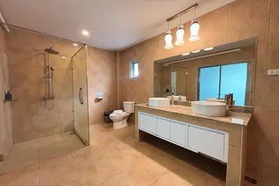 a bathroom with two sinks and a shower at Grand Villa Ishu 4BR Private Pool in Kamala Beach