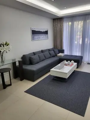a living room with a blue couch and a coffee table at Naithon Beach Pearl of Naithon in Nai Thon Beach