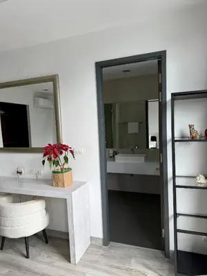 a bathroom with a sink and a table and a mirror at Laguna villa with private pool in Ban Phru Champa